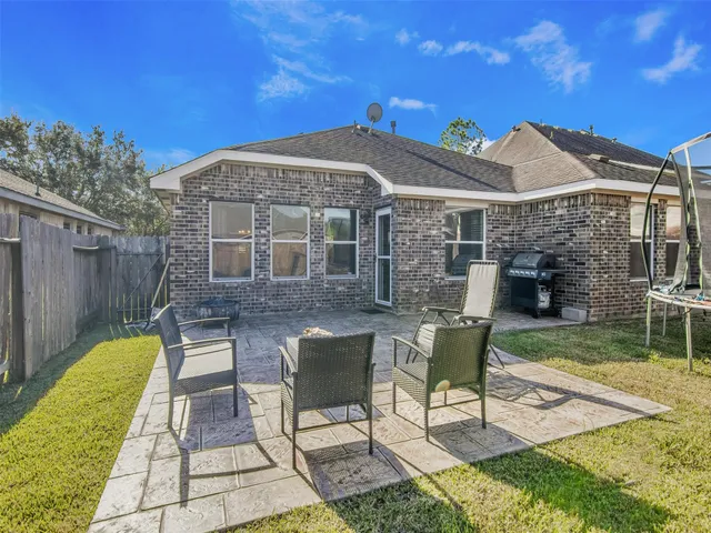 a view of a house with backyard porch and sitting area
