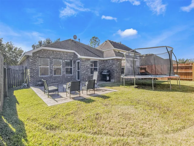 a view of a house with backyard patio and swimming pool