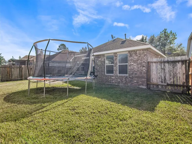 a backyard of a house with a yard table and chairs