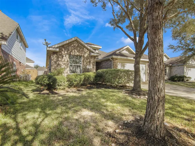 a view of a house with a tree in the background