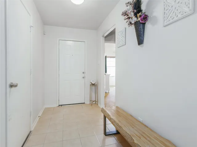 a view of room with a fan & a potted plant
