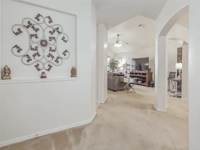 a view of a livingroom with furniture and a kitchen