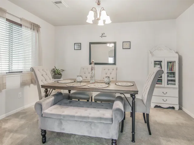 a dining room with furniture and window