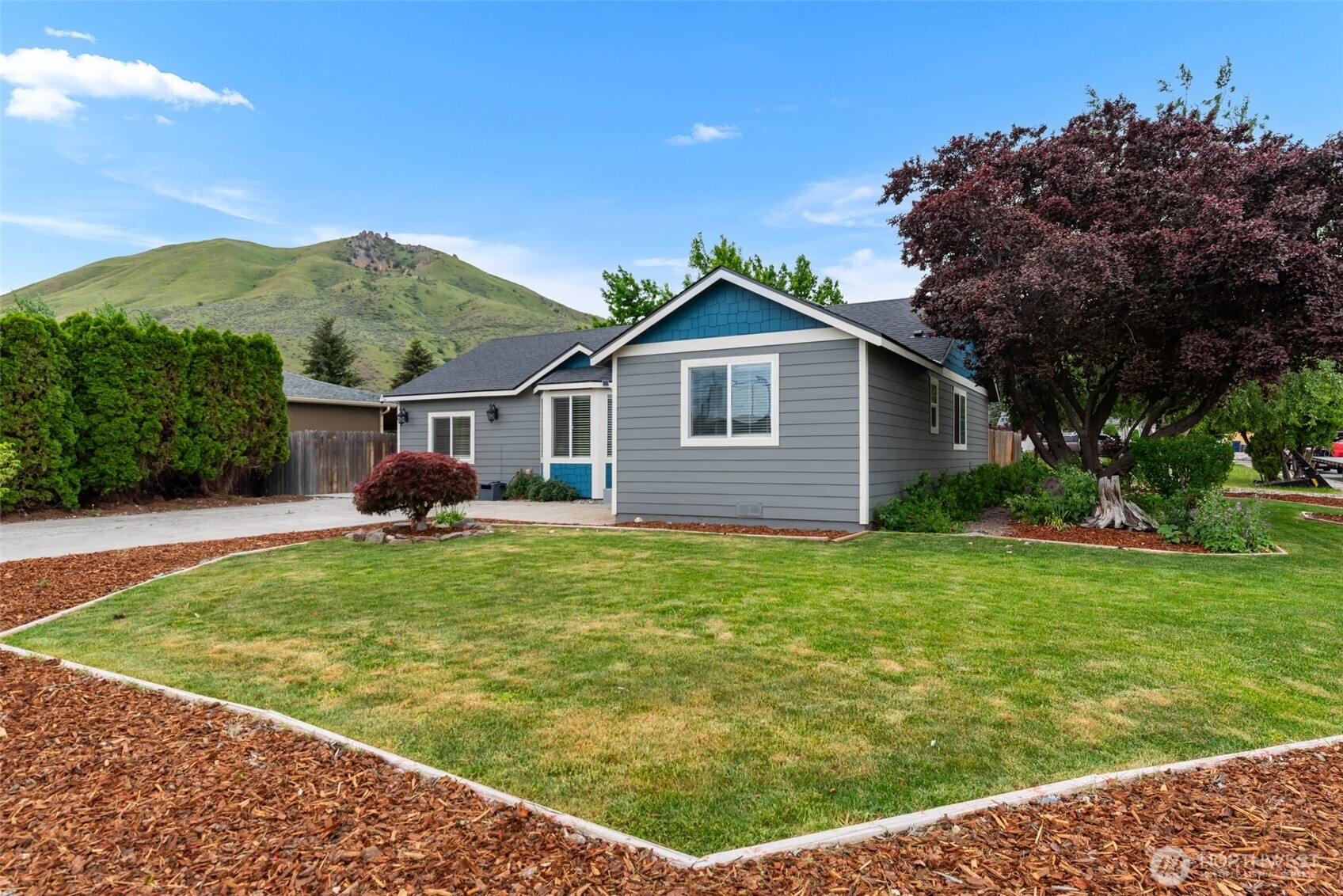 1750 Methow Street Wenatchee, WA 98801 - Photo 1 of 33 a front view of a house with garden