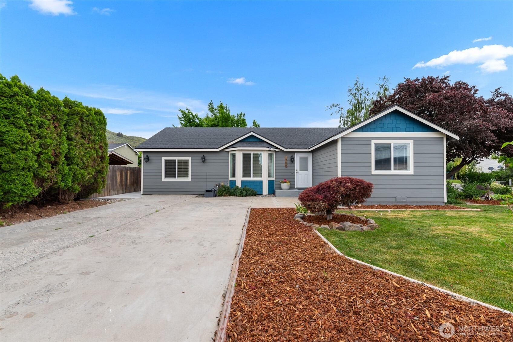 1750 Methow Street Wenatchee, WA 98801 - Photo 2 of 33 a front view of a house with a yard