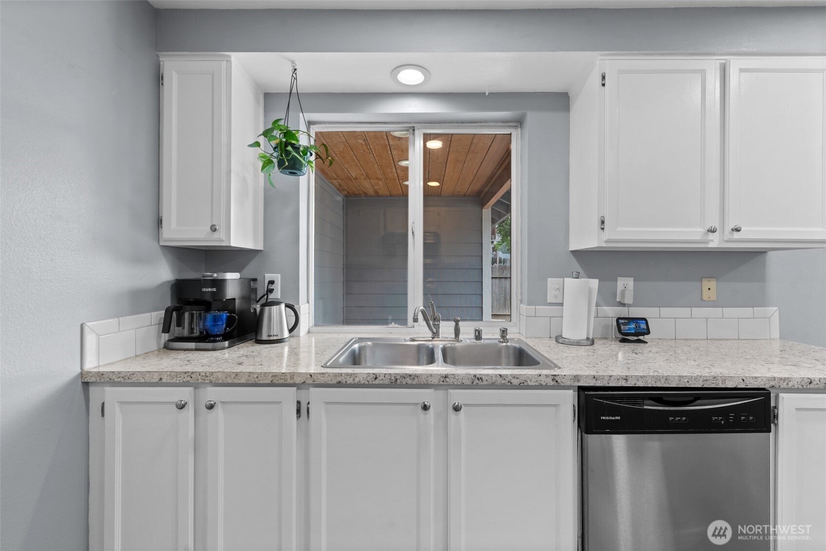 1750 Methow Street Wenatchee, WA 98801 - Photo 22 of 33 a kitchen with granite countertop a sink a stove and cabinets