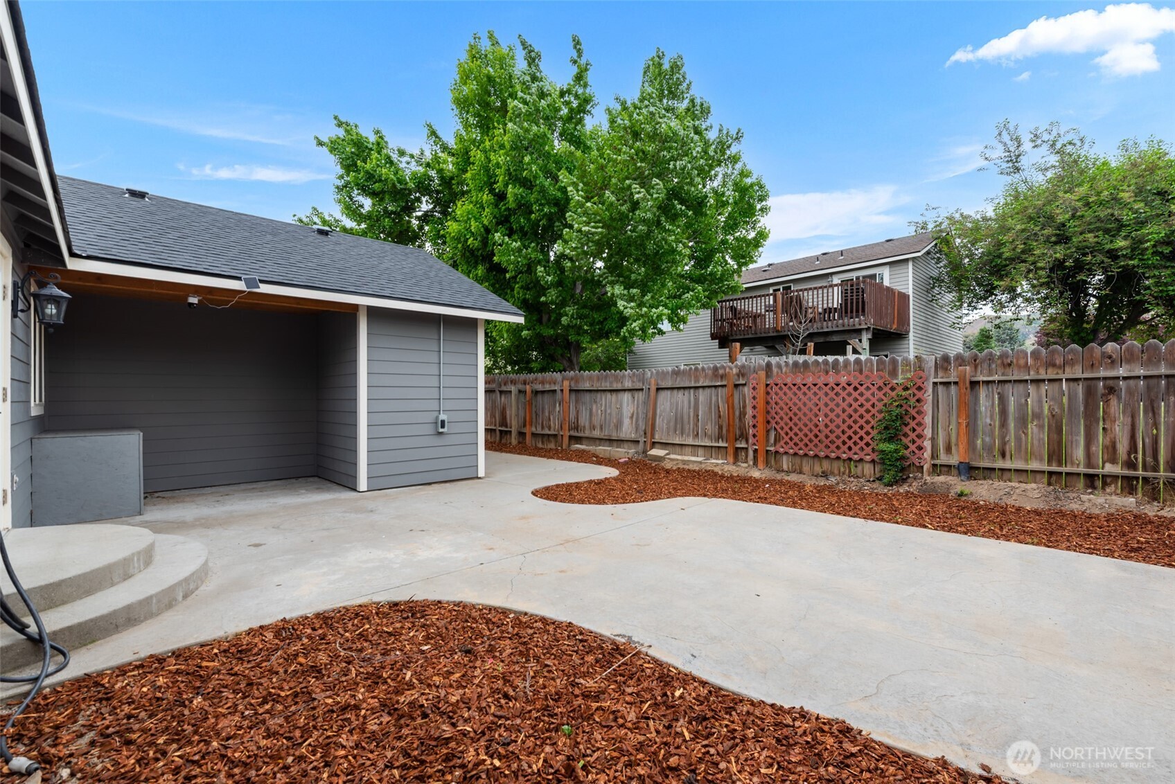 1750 Methow Street Wenatchee, WA 98801 - Photo 31 of 33 a backyard of a house with wooden fence and large trees