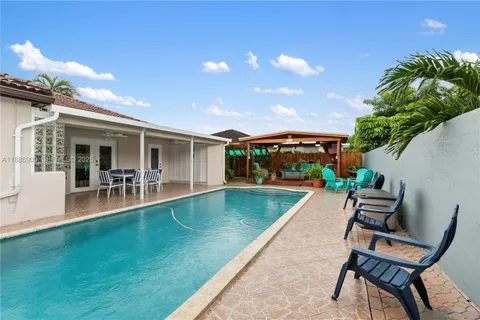 a view of a house with a backyard