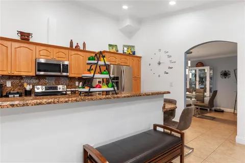 a kitchen with stainless steel appliances granite countertop sink and a granite counter tops