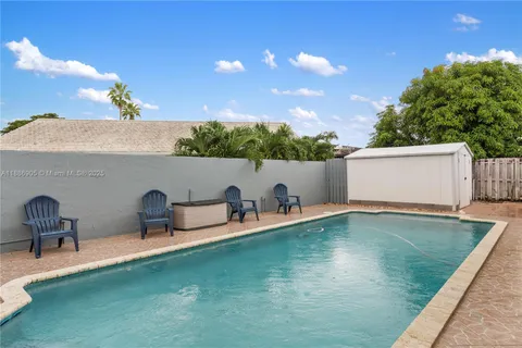 a view of a backyard with sitting area