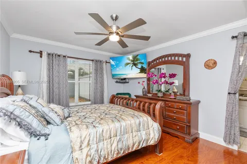 a bedroom with bed cabinet and window