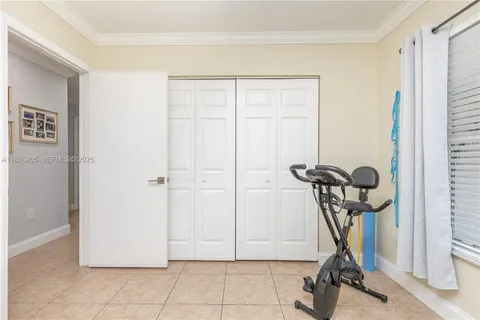 a dining room with furniture and a floor to ceiling window