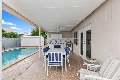 a view of an outdoor dining space with a table and chairs