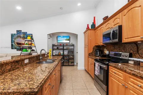 a kitchen with stainless steel appliances granite countertop a stove and a sink