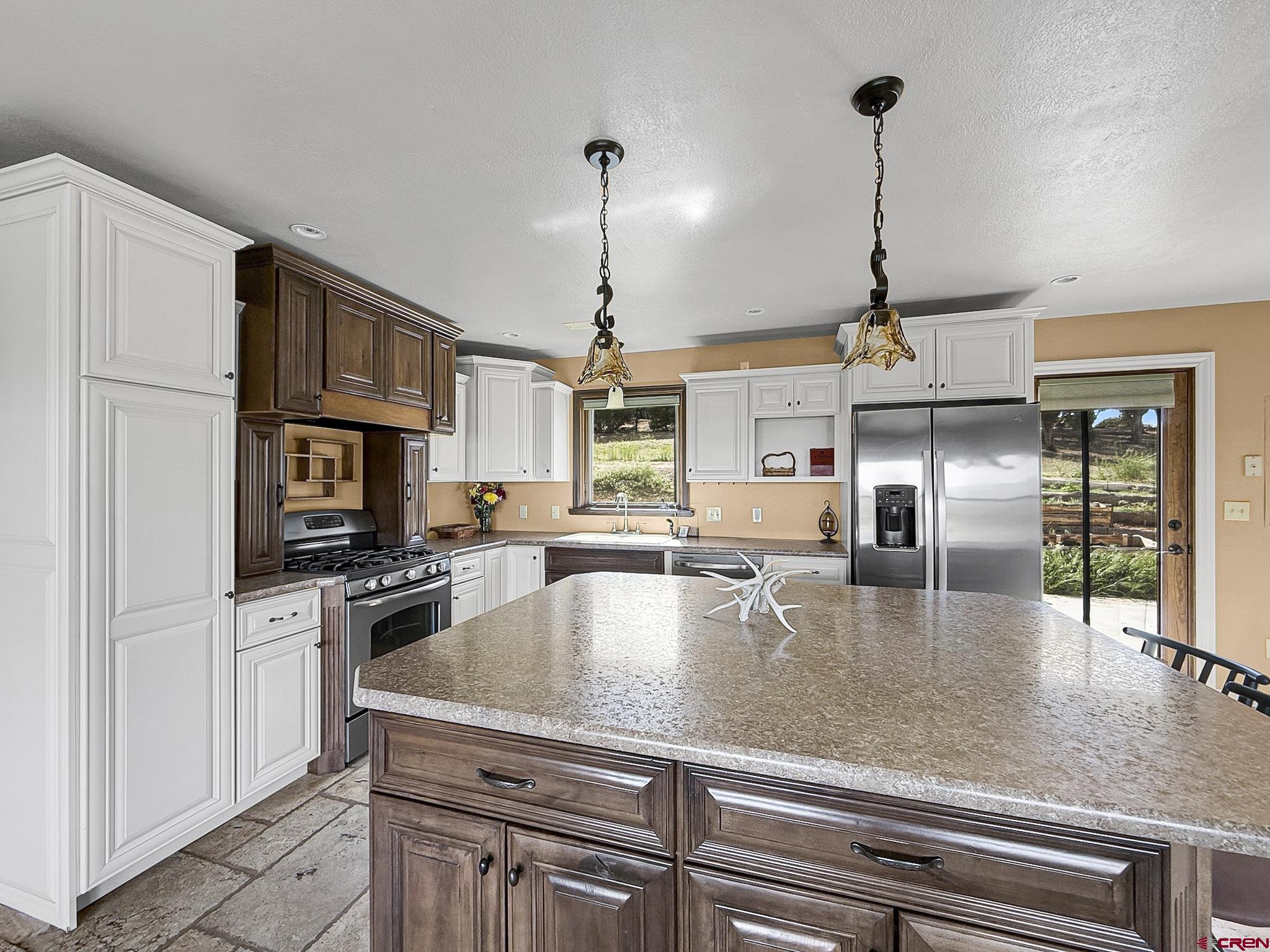32310 B50 Road Crawford, CO 81415 - Photo 15 of 45 a kitchen with stainless steel appliances granite countertop a sink a stove and a refrigerator
