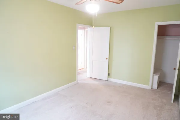 a view of an empty room with a ceiling fan