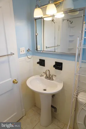 a bathroom with a sink a toilet and a window