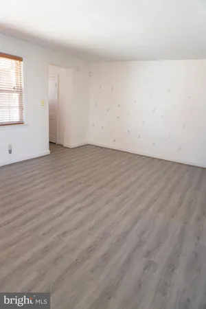 a kitchen with stainless steel appliances a stove a sink dishwasher a refrigerator and a oven with wooden floor