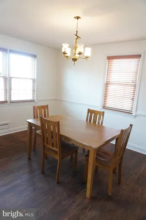 a kitchen with a table chairs sink and cabinets
