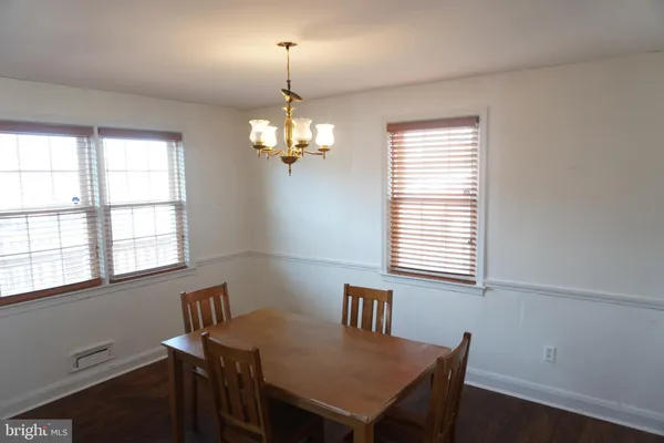 a kitchen with a refrigerator a sink cabinets and wooden floor
