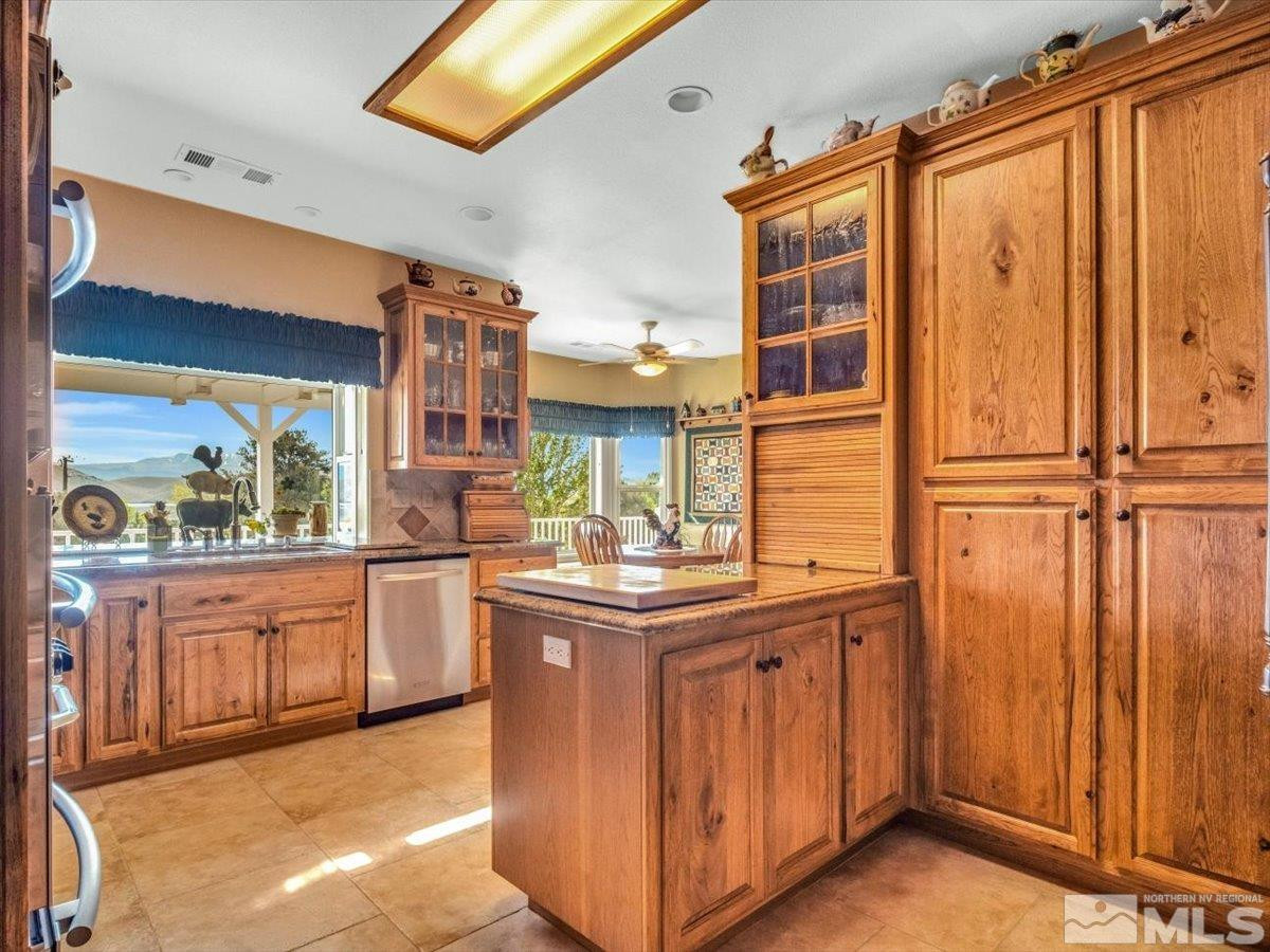 2034 Comstock Drive Gardnerville, NV 89410 - Photo 11 of 40 a kitchen with stainless steel appliances granite countertop a stove a sink and dishwasher