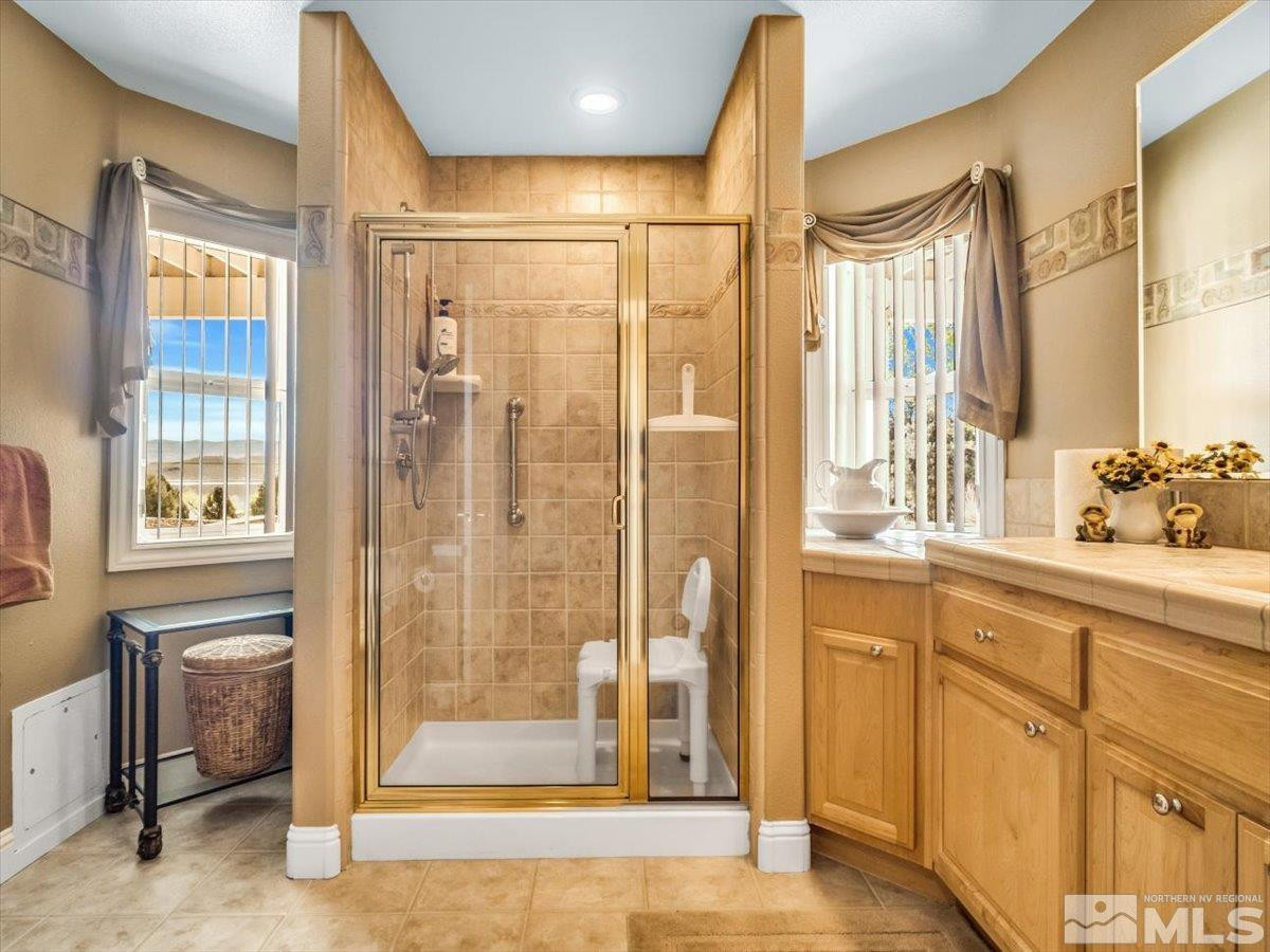2034 Comstock Drive Gardnerville, NV 89410 - Photo 18 of 40 a bathroom with a tub and shower