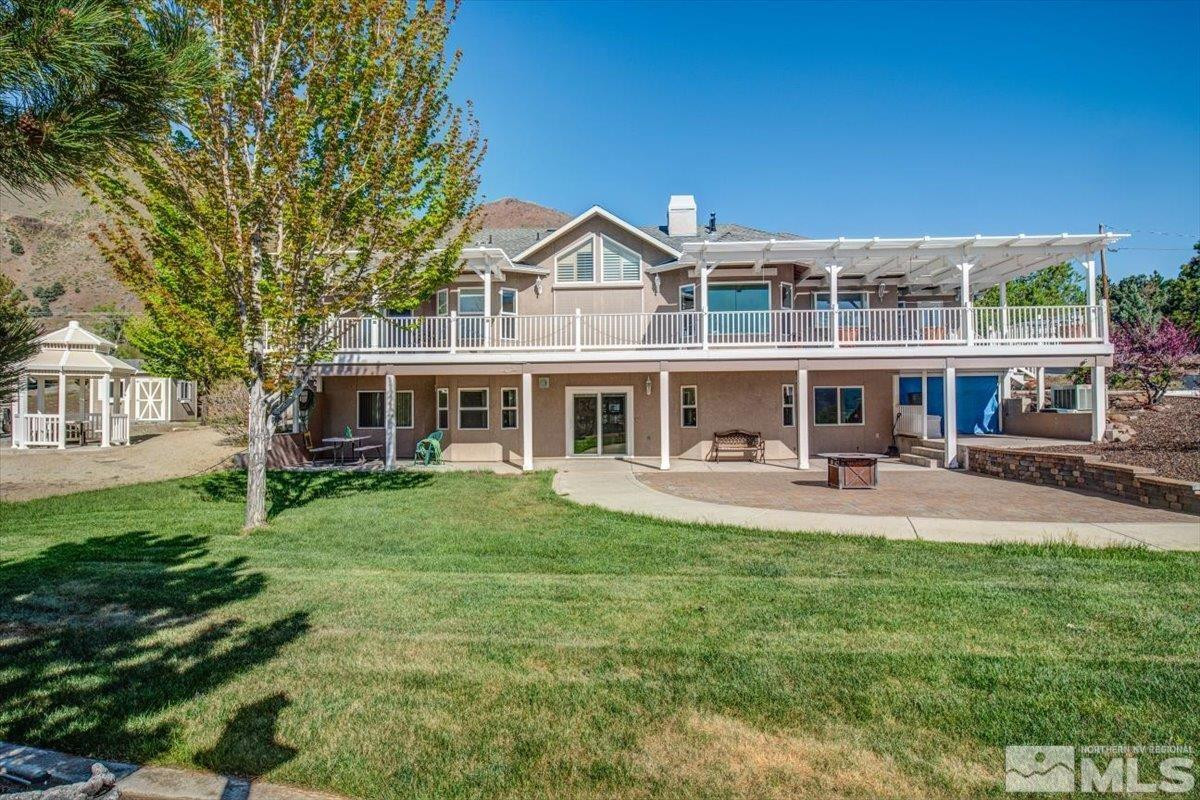 2034 Comstock Drive Gardnerville, NV 89410 - Photo 31 of 40 a front view of a house with yard patio and fire pit