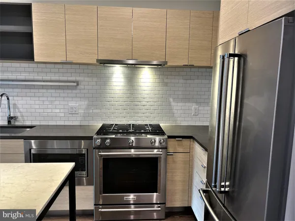 a kitchen with a stove and a refrigerator