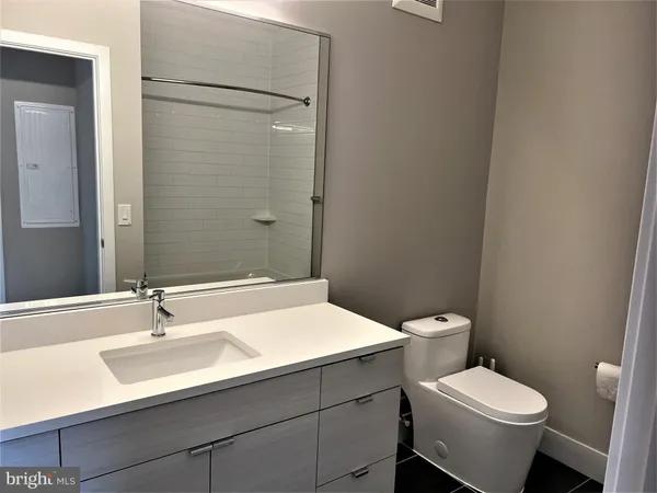 a bathroom with a sink toilet and a mirror