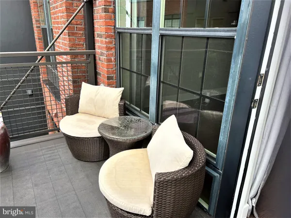 a view of a balcony with chair and glass door
