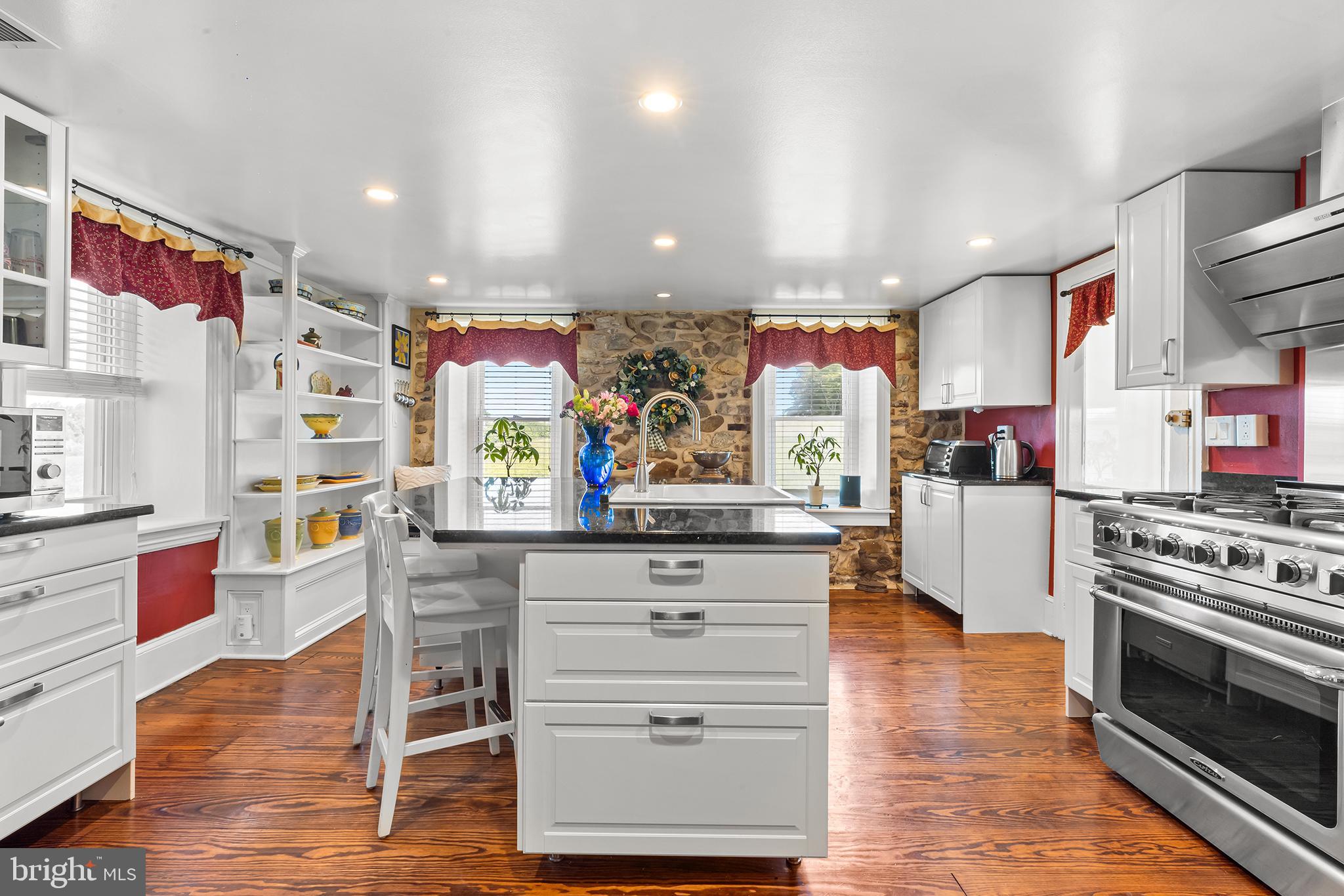 3047 Yellow Springs Road Malvern, PA 19355 - Photo 19 of 68 a kitchen with stainless steel appliances kitchen island granite countertop a stove a sink and a refrigerator
