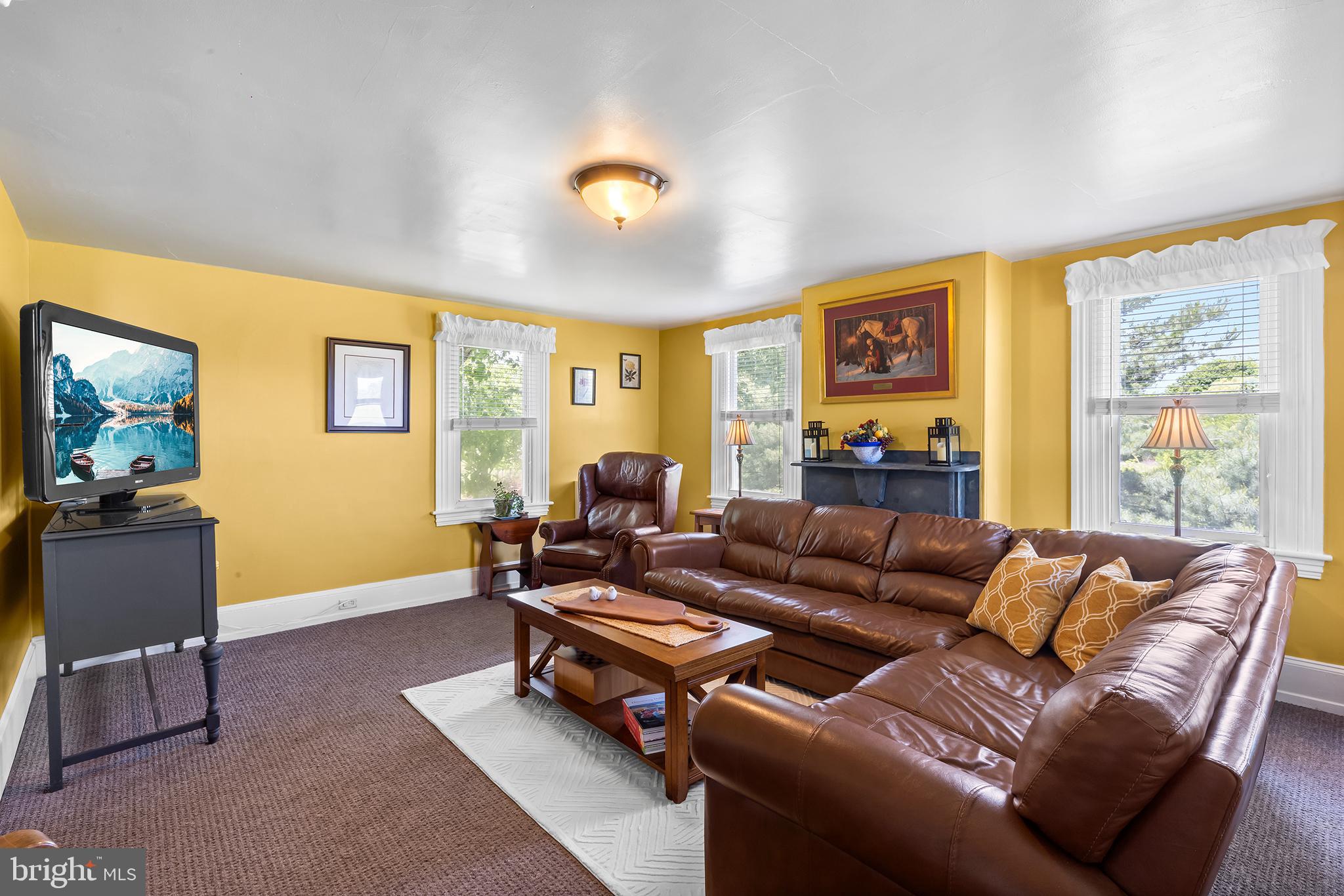 3047 Yellow Springs Road Malvern, PA 19355 - Photo 22 of 68 a living room with furniture a computer on the desk and a large window