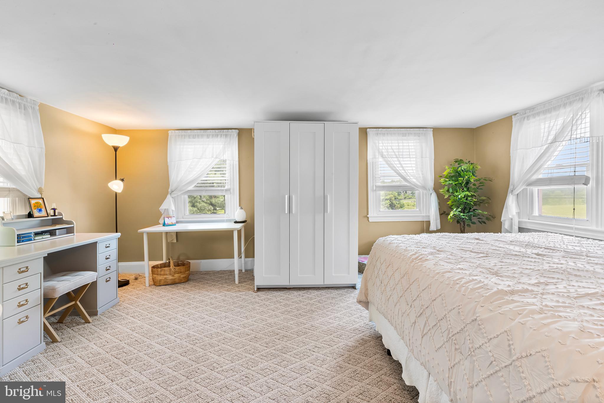 3047 Yellow Springs Road Malvern, PA 19355 - Photo 26 of 68 a bedroom with a bed and large windows
