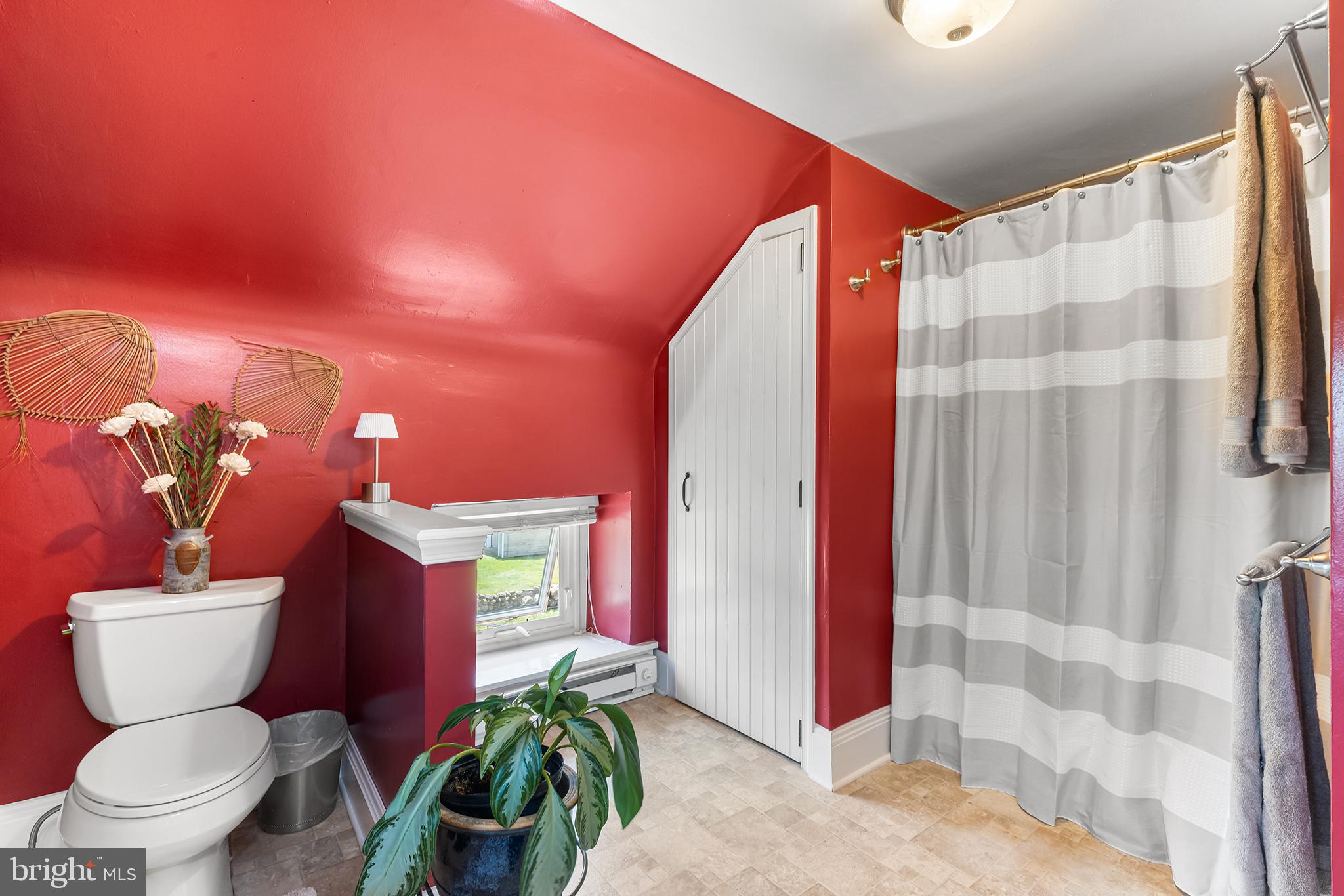 3047 Yellow Springs Road Malvern, PA 19355 - Photo 42 of 68 a bathroom with a toilet a sink and a shower curtain