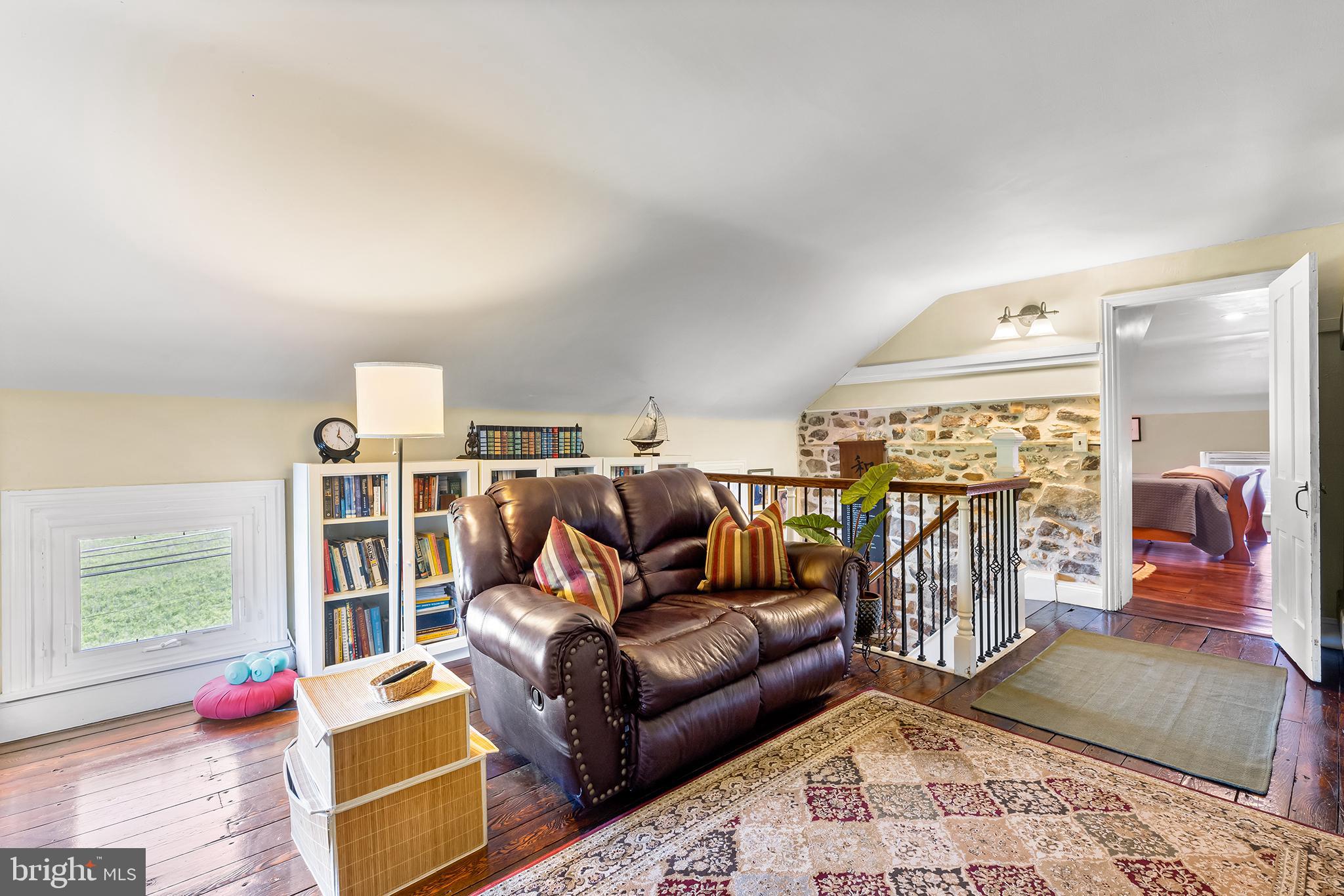 3047 Yellow Springs Road Malvern, PA 19355 - Photo 43 of 68 a living room with furniture a rug and a book shelf