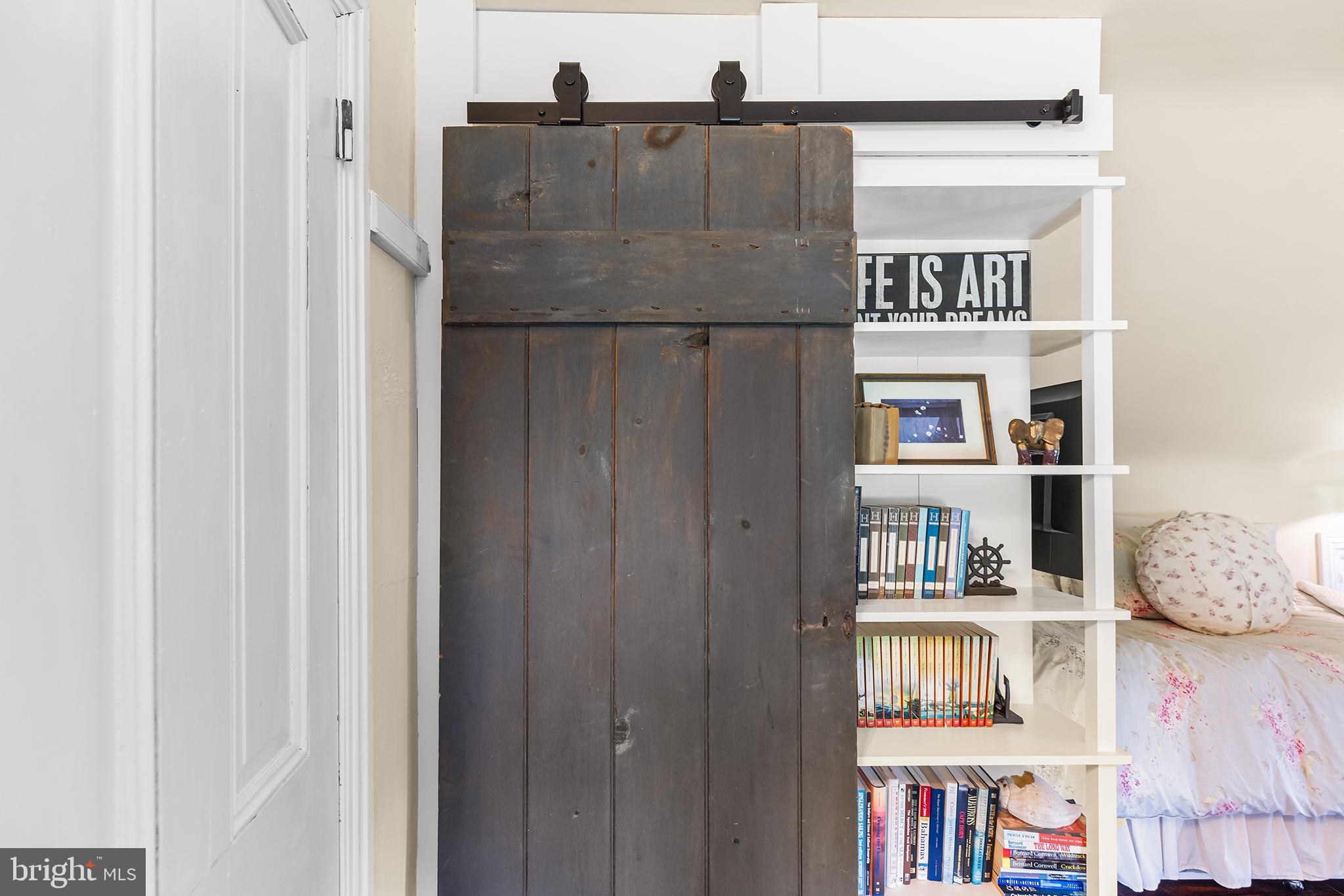 3047 Yellow Springs Road Malvern, PA 19355 - Photo 45 of 68 a living room with a bed and a book shelf