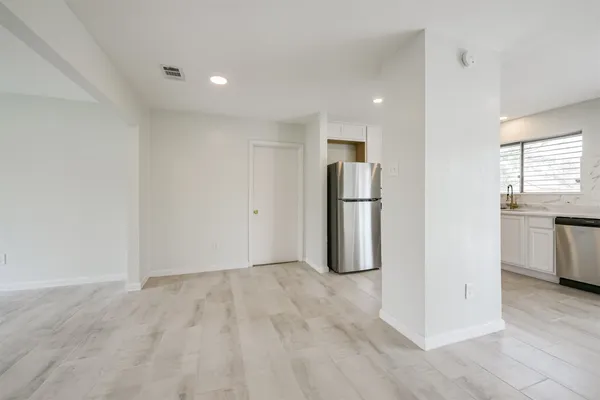 a kitchen with stainless steel appliances white cabinets and a sink