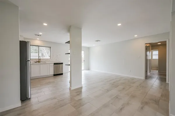 a view of a big room with closet and windows