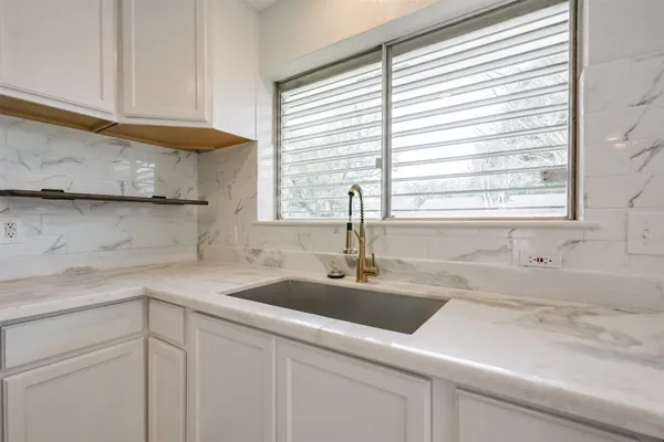 a kitchen with stainless steel appliances granite countertop a refrigerator sink and stove