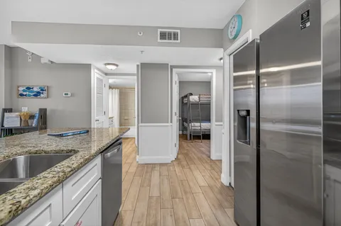 a living room with furniture a chandelier and a potted plant