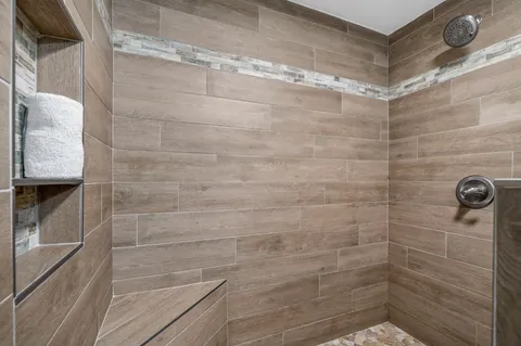 a view of a house with a yard and potted plants