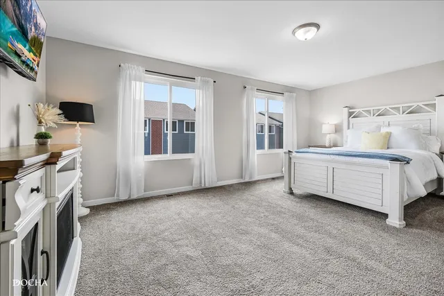 a spacious bedroom with a bed and a cabinets