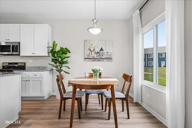 a dining room with furniture and window