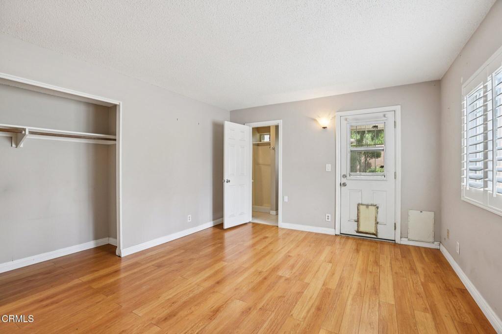 10856 Topeka Drive Porter Ranch, CA 91326 - Photo 13 of 40 an empty room with wooden floor and windows