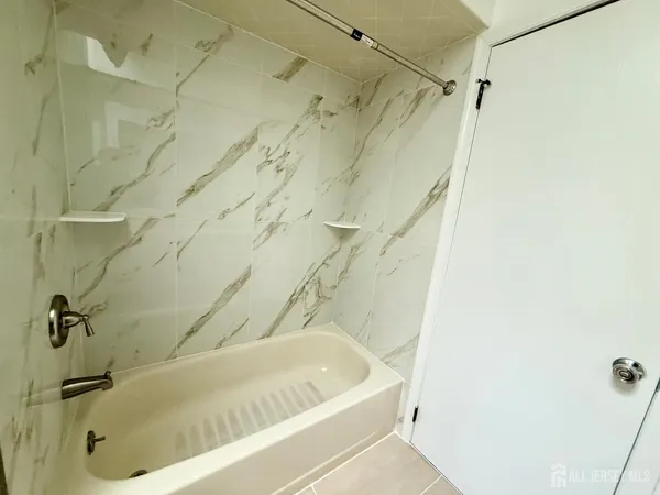 a bath tub sitting next to a shower