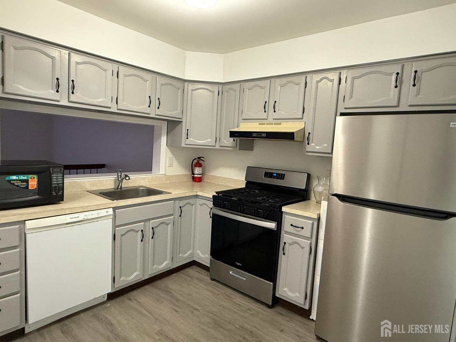 405 Maplecrest Road Edison, NJ 08820 - Photo 4 of 13 a kitchen with stainless steel appliances granite countertop a refrigerator sink and cabinets