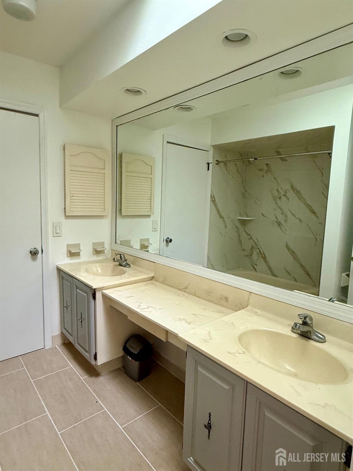 405 Maplecrest Road Edison, NJ 08820 - Photo 9 of 13 a bathroom with a granite countertop sink and a mirror