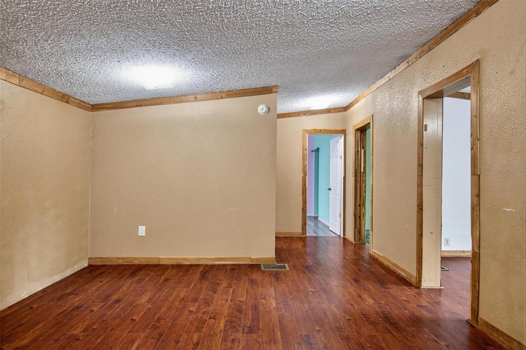 156 Kingfish Road Pomona Park, FL 32181 - Photo 36 of 55 a view of an empty room with wooden floor and a window