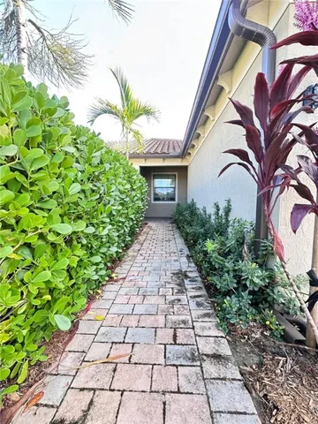 a view of a pathway both side of the house