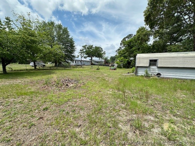 5716 Camden Road Fayetteville, NC 28306 - Photo 2 of 10 a view of a green field with trees in the background